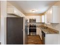 Modern kitchen featuring stainless steel appliances, granite countertops, and white cabinetry at 3499 Villa Se Cir, Atlanta, GA 30354
