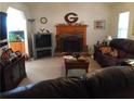 Inviting living room features a brick fireplace and ample space for relaxation and entertainment at 443 Hannah Dr, Temple, GA 30179
