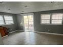 Open-concept living room with large windows, a sliding door to the exterior and tiled flooring at 96 Sir Scott Ct, Lawrenceville, GA 30044