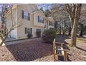 Charming suburban home featuring a well-manicured lawn and a cozy bench to enjoy the outdoors at 255 N Loblolly Xing, Temple, GA 30179