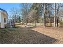 Large grassy backyard with a wooden fence, ideal for outdoor activities and privacy at 4550 Wenden Ln, Marietta, GA 30062