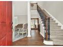 Inviting foyer with hardwood floors, staircase, and a glimpse of the living room at 559 Fairway Dr, Woodstock, GA 30189