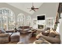 Bright living room with hardwood floors, fireplace, built-in shelving and large arched windows at 559 Fairway Dr, Woodstock, GA 30189