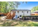 Spacious backyard features a wooden deck, lush greenery, and a private, fenced yard for outdoor enjoyment at 1048 Brookdale Dr, East Point, GA 30344