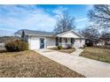 Inviting single-story home with a long driveway, covered porch, and side entrance at 202 Porter Ln, Jonesboro, GA 30236