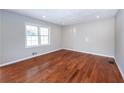 Bright living room featuring gleaming hardwood floors, recessed lighting and large windows at 202 Porter Ln, Jonesboro, GA 30236