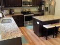 Well-equipped kitchen featuring granite countertops, stainless steel appliances, and dark wood cabinetry at 1101 Senator Rd, Douglasville, GA 30134