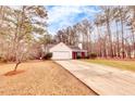 Well-maintained one-story home with a spacious driveway and traditional design elements at 122 Lakepointe Court, Stockbridge, GA 30281