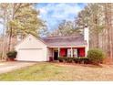 Quaint single-level house with a well-kept front yard, garage, and cozy porch at 122 Lakepointe Court, Stockbridge, GA 30281