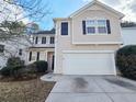 Charming two-story home featuring a two-car garage, black shutters, and a well-maintained driveway at 3160 Sable Trl, Atlanta, GA 30349