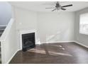 Bright living room with a modern fireplace, ceiling fan, and new flooring at 3160 Sable Trl, Atlanta, GA 30349