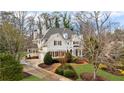 Elegant home with meticulous landscaping, charming dormers, and an inviting circular driveway and attached garage at 2616 Boddie Pl, Duluth, GA 30097