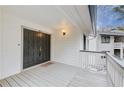 Inviting front door with dark wood and a charming porch at 3817 Paces Ferry West, Atlanta, GA 30339