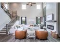 Bright, airy living room with a cozy fireplace, two-story windows, and hardwood floors at 727 Crossroad Ct, Powder Springs, GA 30127