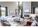 Cozy living room featuring a fireplace, high ceilings, and ample natural light at 727 Crossroad Ct, Powder Springs, GA 30127