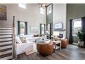 Bright, airy living room with a cozy fireplace, two-story windows, and hardwood floors at 727 Crossroad Ct, Powder Springs, GA 30127