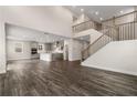 Open-concept living room featuring hardwood floors and staircase overlooking the kitchen at 727 Crossroad Ct, Powder Springs, GA 30127