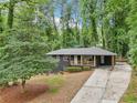 Beautiful exterior view of a single-story home featuring a covered front porch and long driveway at 2210 Bolling Brook Sw Dr, Atlanta, GA 30311