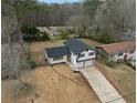 Aerial view of home with black roof, garage, fenced yard, and driveway in mature neighborhood at 2385 Tiffany Pl, Decatur, GA 30035