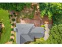 Aerial view of a backyard featuring a wooden deck, landscaping and a well-maintained roof at 274 Westchester Club Dr, Hiram, GA 30141