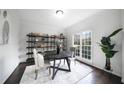 Bright dining room featuring a dark wood table, stylish chairs, and decorative shelving at 1165 Pin Oak Ct, Cumming, GA 30041