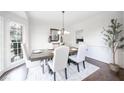 Elegant dining room with hardwood floors, chandelier, and ample natural light at 1165 Pin Oak Ct, Cumming, GA 30041