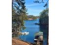 Scenic lake view showcasing clear blue waters, mature trees, and a boat dock at 3330 Chimney Point Dr, Cumming, GA 30041