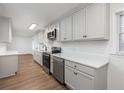 Well-lit kitchen equipped with stainless steel appliances, white cabinets, and sleek countertops at 365 Cowan Rd, Covington, GA 30016