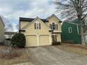 Two-story home with a two-car garage, neutral paint, mature tree and lawn at 430 Citronelle Dr, Woodstock, GA 30188