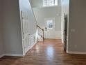 Inviting foyer with hardwood floors, white trim, and staircase with wood handrail at 430 Citronelle Dr, Woodstock, GA 30188