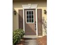 Close-up of a front door with sidelights, traditional hardware, and a secure smart lock at 430 Citronelle Dr, Woodstock, GA 30188