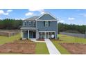 Inviting two-story home with a blue exterior, a well-manicured front yard, and a covered entry at 125 Maplewood Ln, Conyers, GA 30094