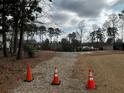 Vacant lot marked with traffic cones for future building site in wooded area at 120 Woodlawn Dr, Marietta, GA 30067