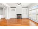 Light-filled living room with fireplace, custom built-ins, hardwood floors, and elegant architectural details at 2300 Peachford Rd # 3411, Atlanta, GA 30338