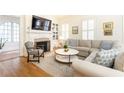 Bright living room with hardwood floors, fireplace, built-in shelves, and comfortable seating at 2911 N Hills Ne Dr, Atlanta, GA 30305