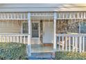 Inviting porch featuring stone details, a bright white door, and decorative holiday lighting at 3109 Meadow Wood Ct, Lawrenceville, GA 30044