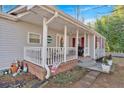 Inviting front porch with decorative elements, complemented by brick accents and a well-maintained exterior at 6106 Misty Valley Se Dr, Acworth, GA 30102