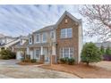 Charming two-story home featuring a two-car garage, brick accents and a welcoming front porch at 2341 Walnut Tree Ct, Buford, GA 30519