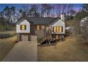Exterior shot of a charming home with an inviting front entrance and a well-maintained lawn at 2121 Lindley Nw Ln, Kennesaw, GA 30144