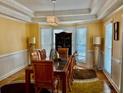 Elegant dining room with tray ceiling, bay window, and stylish decor at 1230 Mars Hill Nw Rd, Acworth, GA 30101