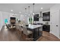 Open-concept kitchen with island seating, stainless steel appliances, and a view of the living room at 133 Old Alabama Se Rd, Emerson, GA 30137
