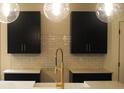 Close-up of kitchen with a stylish faucet, black cabinets, white countertops, and white subway tile backsplash at 133 Old Alabama Se Rd, Emerson, GA 30137