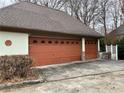 Attached two car garage featuring paneled doors and an adjacent garden at 1920 Anastasia Ln, Atlanta, GA 30341