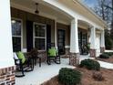 Inviting front porch with rocking chairs and brick accents, creating a cozy outdoor living space at 625 Aunt Lucy, Ste 7 Sw Ln, Smyrna, GA 30082