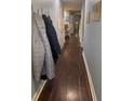 Entryway hallway with hardwood floors, coat hooks, and doors leading to various rooms at 233 Tara Commons Walk, Loganville, GA 30052