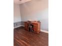 This room features hardwood flooring, a wooden desk, and a wire dog kennel at 233 Tara Commons Walk, Loganville, GA 30052
