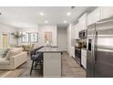 Bright kitchen with granite counters, stainless appliances, island seating, and open floorplan at 1342 Magnolia Way Bnd # 287, Jonesboro, GA 30238