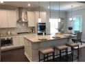 Well-appointed kitchen with granite countertops, stainless steel appliances and a center island at 3686 Thornhill Ct, Douglasville, GA 30135