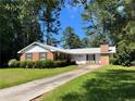 Traditional brick ranch home with a well-maintained lawn and mature trees at 5336 David Cir, Covington, GA 30014