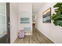 Bright entryway with wood flooring, leading into the house with welcome bench and decorative artwork displayed at 9450 Cedar Grove Ct # 332, Jonesboro, GA 30238